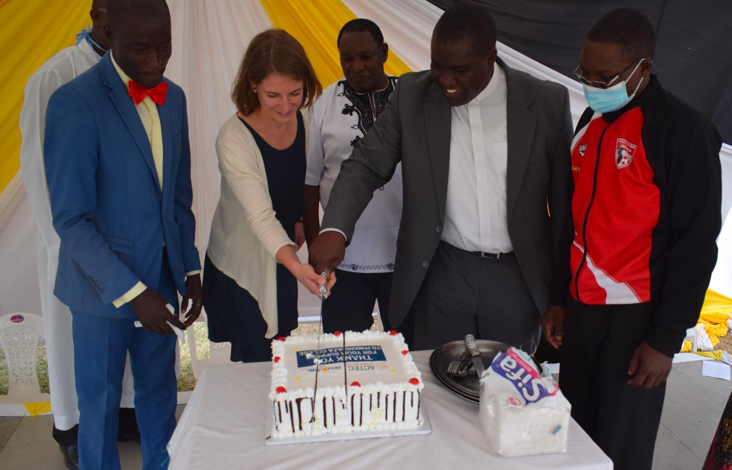 Mwangaza College people cutting a cake